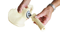 man demonstrating artificial hip joint