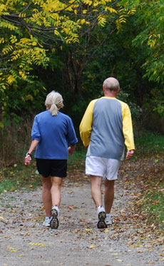 older couple walking on trail